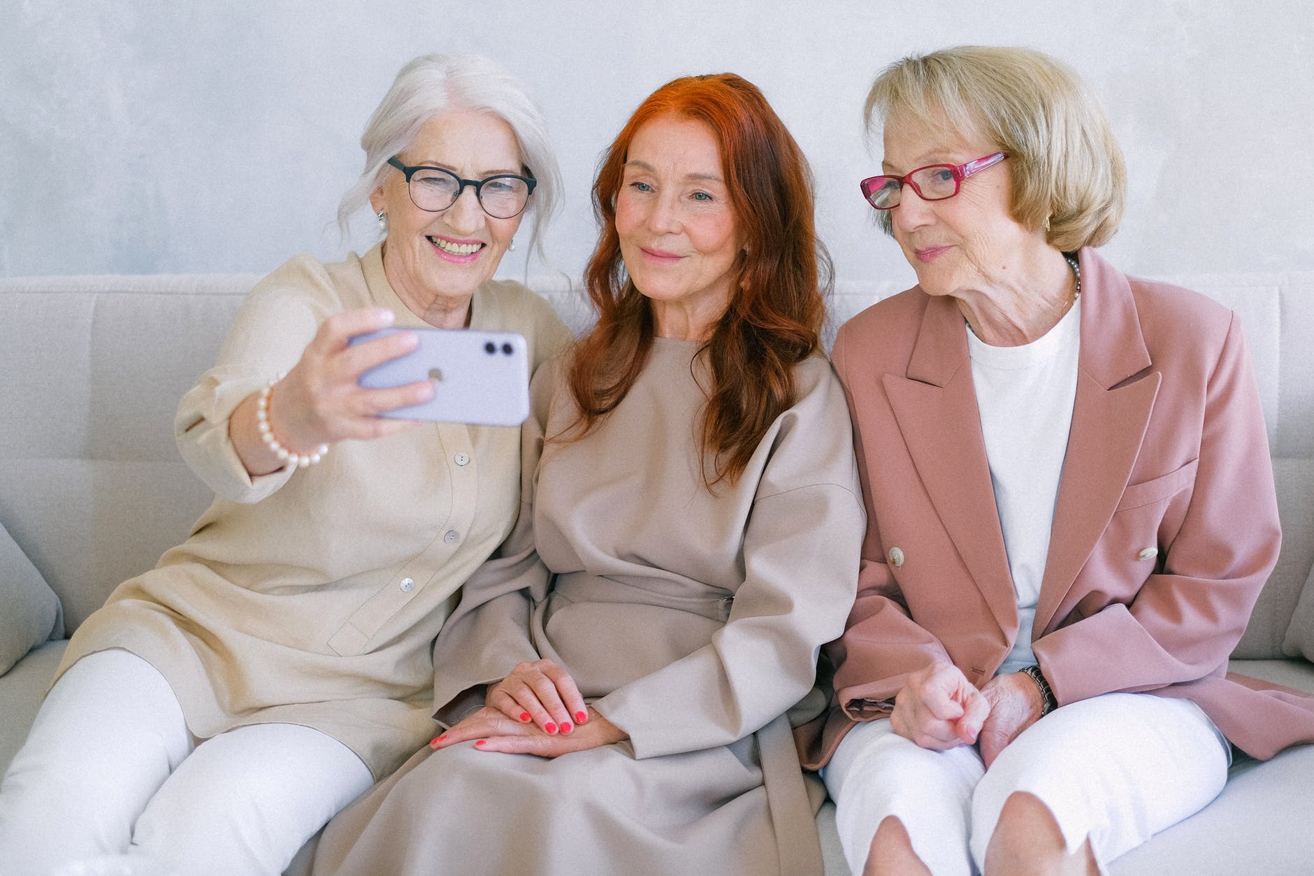 aged happy women making video call online on smartphone